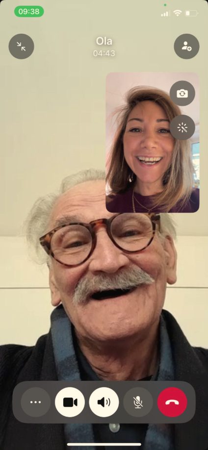 Video call: Dela smiling in a small window, her father laughing in the main picture.